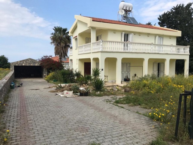 A 3+ 1 villa for sale with a large living room with a fireplace and a kitchen with a sea view on hal